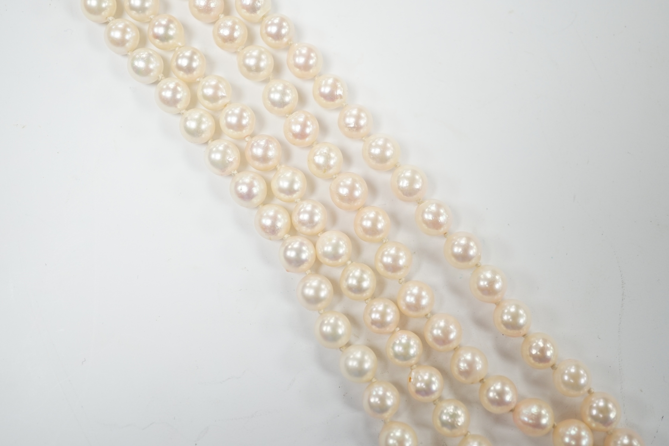 A double strand cultured pearl necklace, with cabochon sapphire and diamond chip cluster set 14k clasp, 44cm. Good condition.